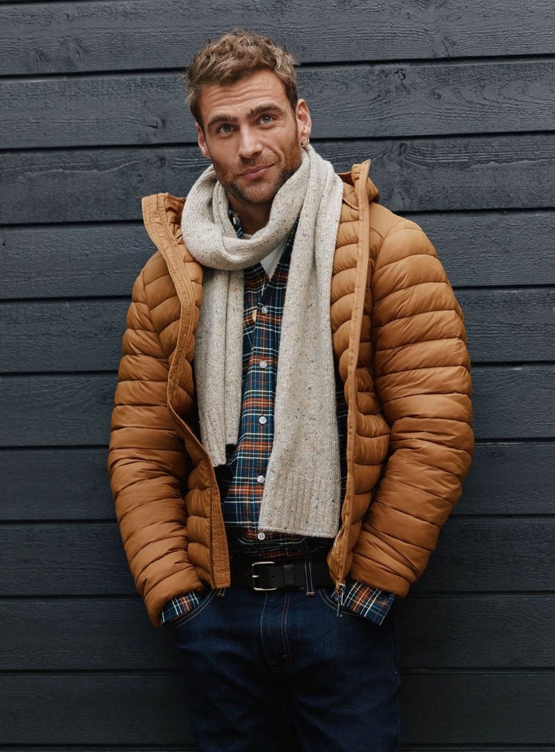 Wrapped in a snug scarf and a puffy caramel jacket, George Alsford embodies winter charm for Simon's Le 31.