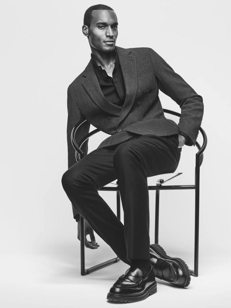 Corey Baptiste wears a double-breasted jacket and trousers from Giorgio Armani Made to Measure. 