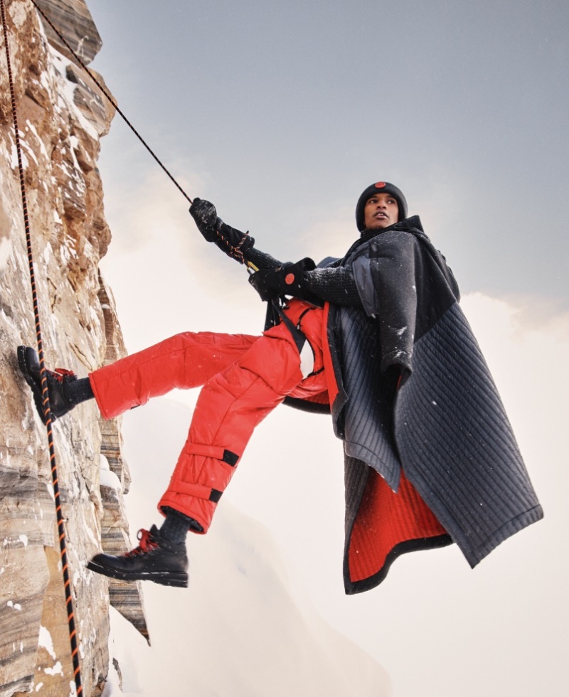 Climbing, Ibrahim Idoow wears a Giorgio Armani Neve cape over salopettes. 
