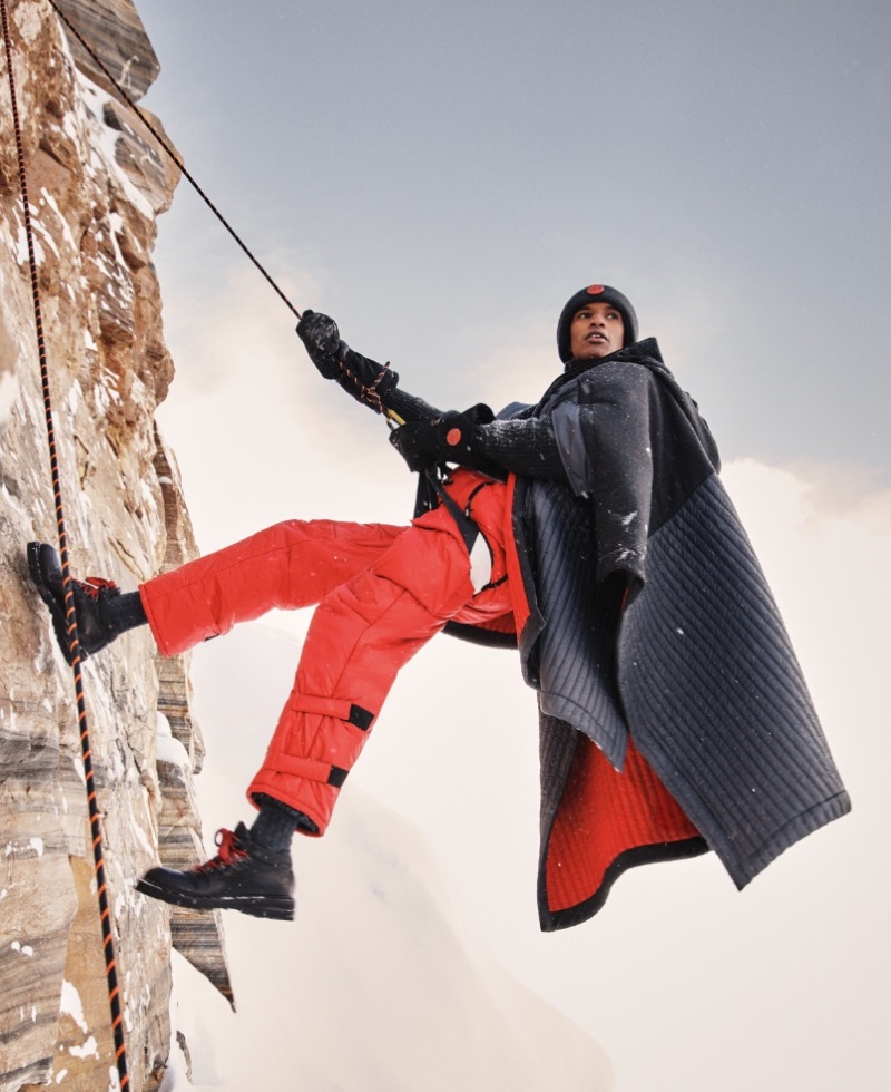 Climbing, Ibrahim Idoow wears a Giorgio Armani Neve cape over salopettes. » Giorgio Armani Neve Elevates Winter with Alpine Elegance Climbing, Ibrahim Idoow wears a Giorgio Armani Neve cape over salopettes.