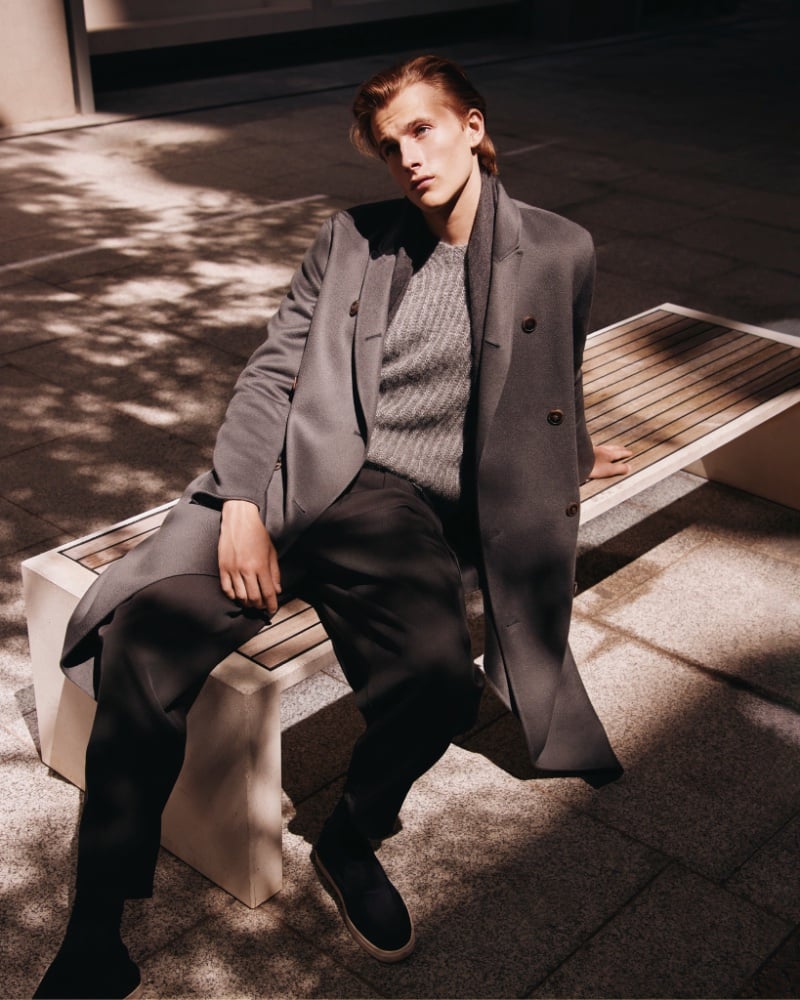 Selfridges' Giorgio Armani unisex collection, featuring Oden Delargy in a structured grey overcoat layered over a knit sweater.