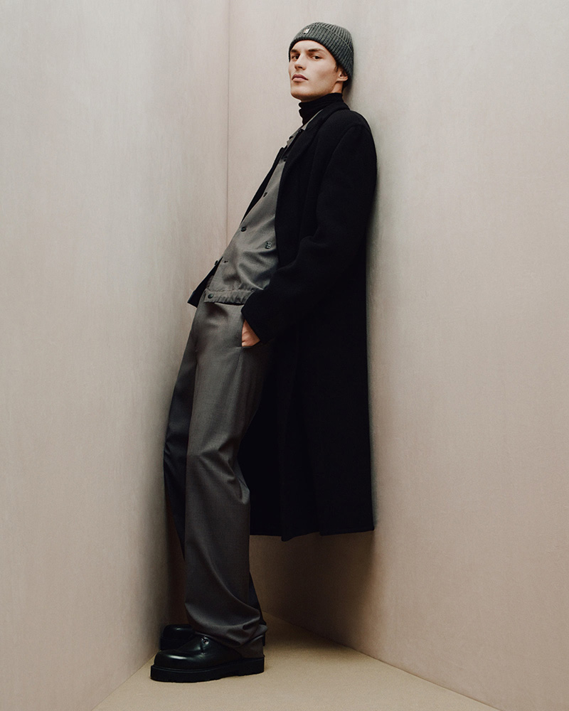Kit Butler exudes a relaxed elegance in a long black coat, layered over a charcoal suit, paired with a beanie and chunky boots for Givenchy's Holiday 2023 campaign. » Givenchy Highlights New Elegance for Holiday 2023 Campaign Kit Butler exudes a relaxed elegance in a long black coat, layered over a charcoal suit, paired with a beanie and chunky boots for Givenchy's Holiday 2023 campaign.