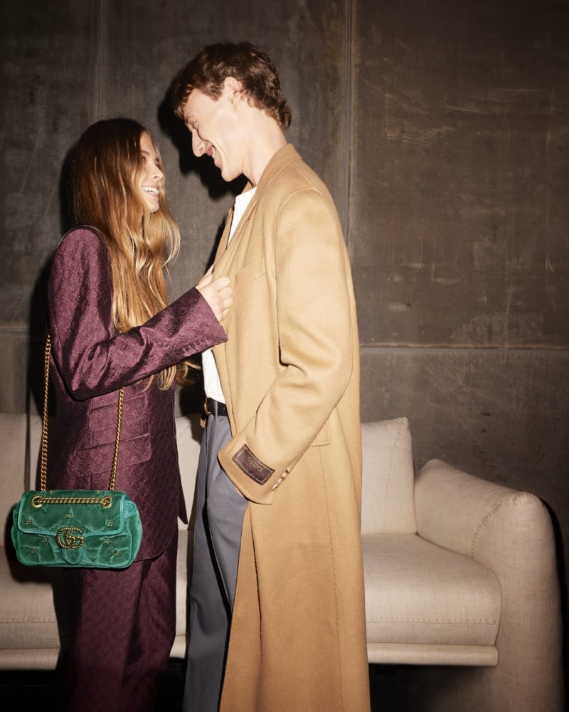 A joyous moment in luxury, as a couple share a laugh in the glow of Gucci's timeless elegance. 
