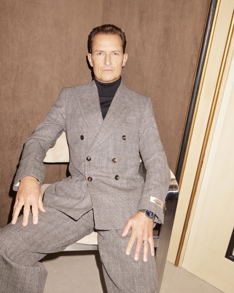 Confidence personified, Jonathan Norman sits poised and polished in a Gucci ensemble that redefines modern suave.