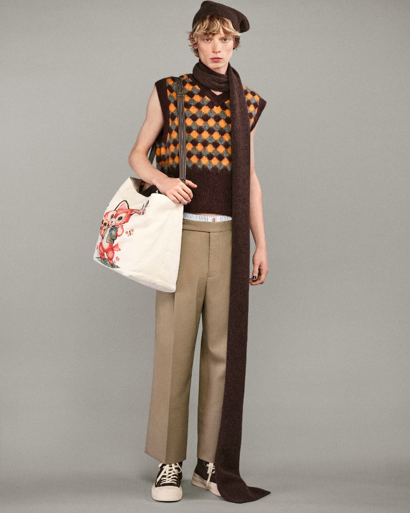 Owen embraces autumnal hues with a Harry Lambert for Zara Cutie Chaos argyle vest, pleated trousers, and a whimsical tote. 