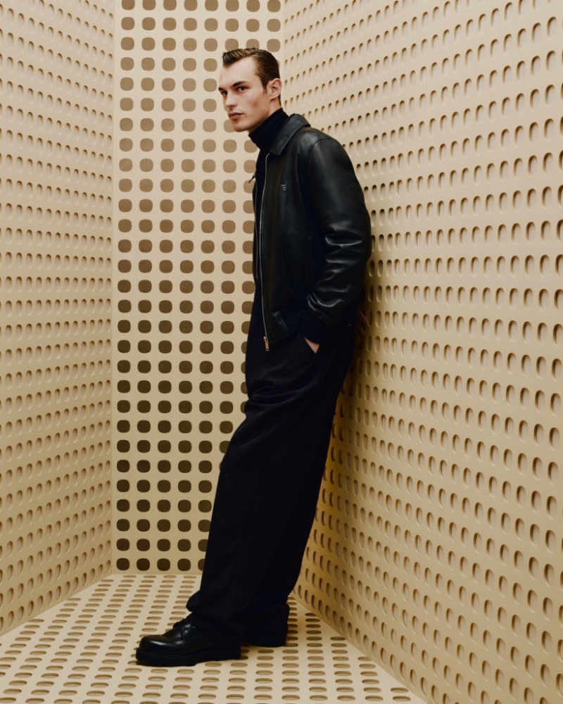British model Kit Butler dons all black for Givenchy's holiday 2023 campaign.