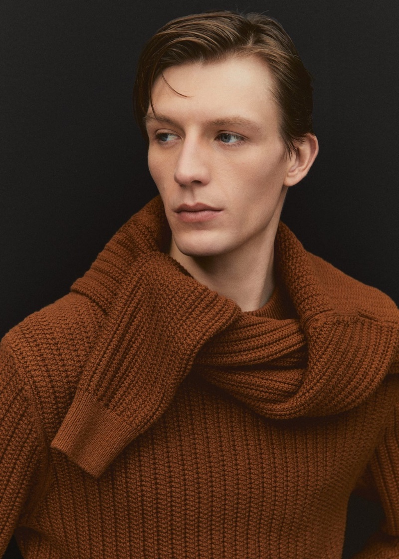 Finnlay Davis layers brown knitwear from Mango's fall-winter 2023 collection. 