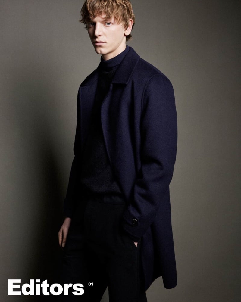 Igor Vojinovic wears a look from Massimo Dutti's winter 2023 collection, featuring a sophisticated navy overcoat layered over a turtleneck.