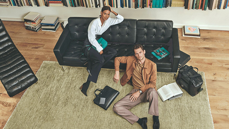 Liya Kebede and Garrett Neff lounge casually among Montblanc's fine leather goods in a setting of intellectual charm.