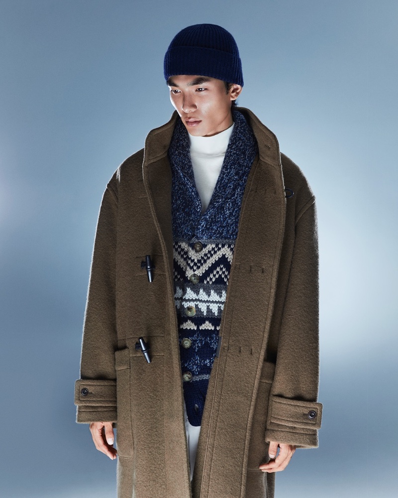 Layering for the cold, Keon Hee Lee wears a LEMAIRE virgin wool duffel coat and cotton jersey turtleneck top with a Brunello Cucinelli cashmere beanie and jacquard cardigan. 