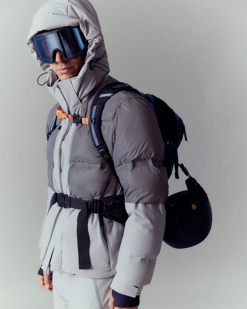 Jivago Santini gears up in Aztech Mountain's high-performance skiwear, with a helmet in hand, he's the picture of readiness for the thrill of the slopes.
