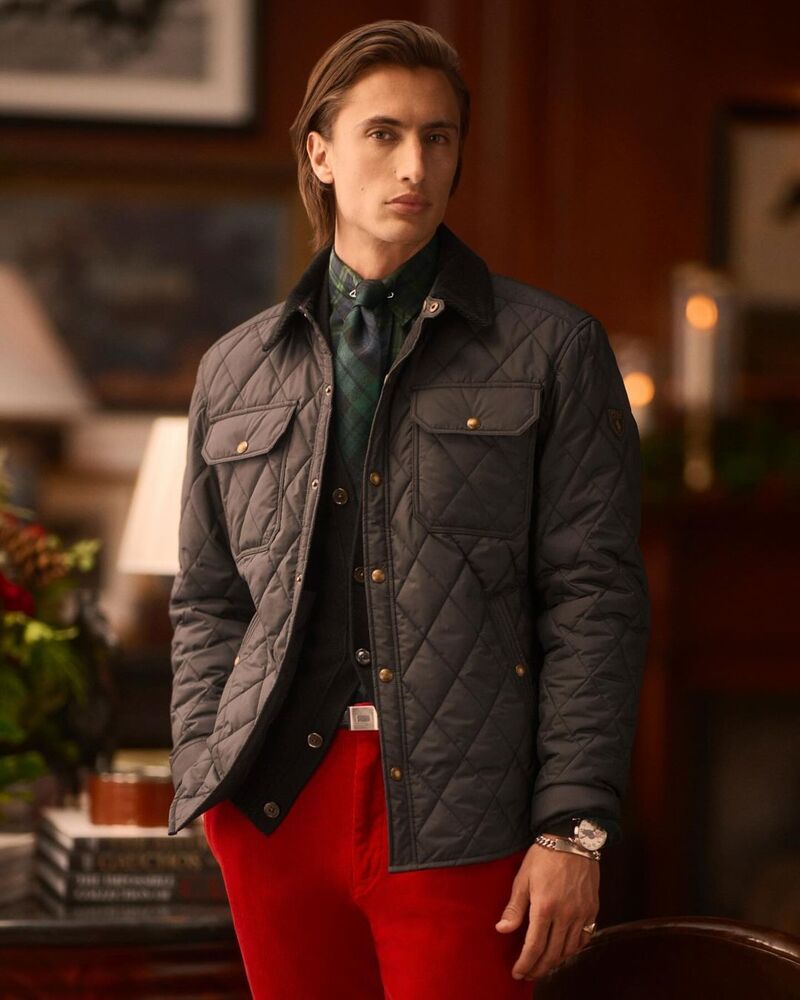 James Turlington models a Polo Ralph Lauren holiday ensemble featuring a quilted jacket and red pants.