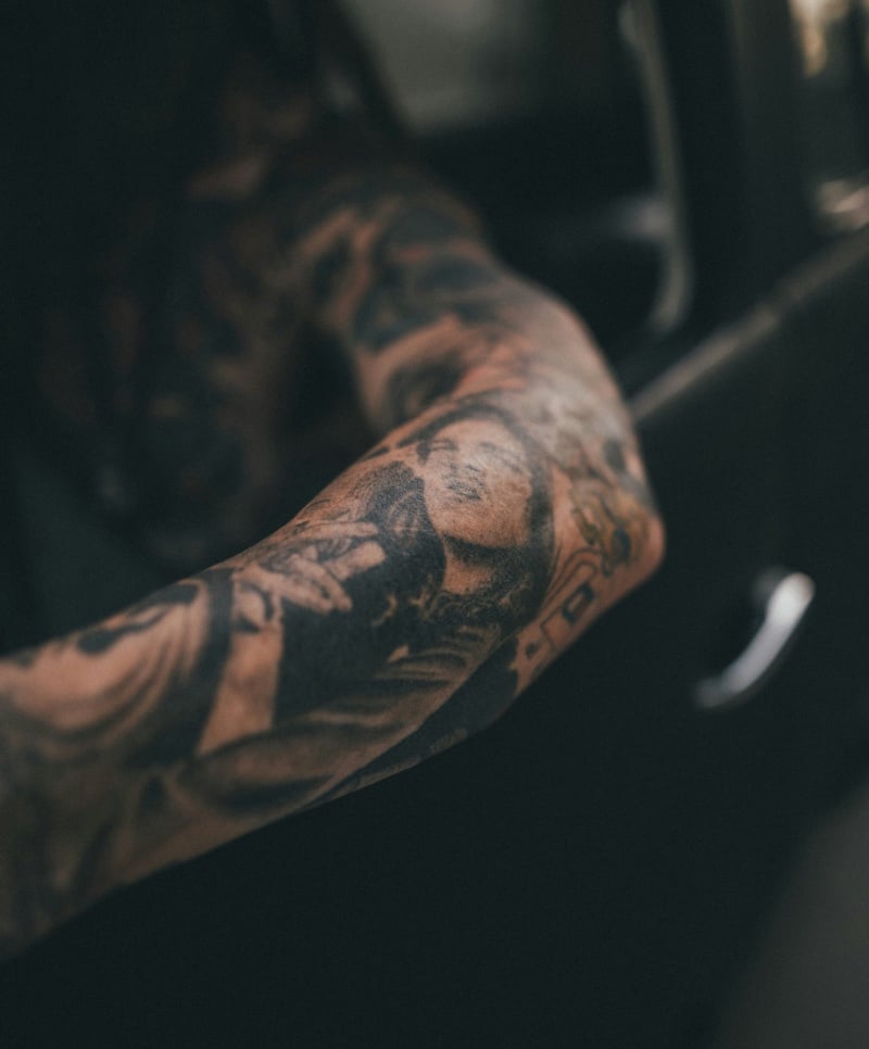 A detailed portrait graces the forearm, a personal gallery of memories and moments captured in ink.