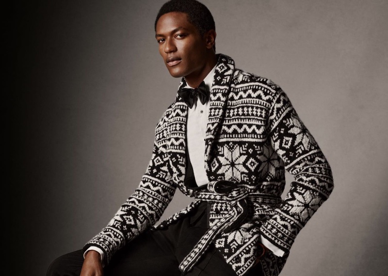 Hamid Onifade dons a hand-knit belted cardigan sweater by Ralph Lauren Purple Label.