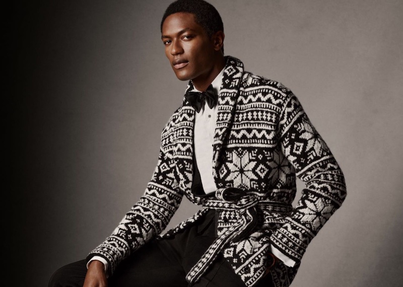 Hamid Onifade dons a hand-knit belted cardigan sweater by Ralph Lauren Purple Label. » Ralph Lauren Purple Label Unwraps a Festive 2023 Holiday Hamid Onifade dons a hand-knit belted cardigan sweater by Ralph Lauren Purple Label.