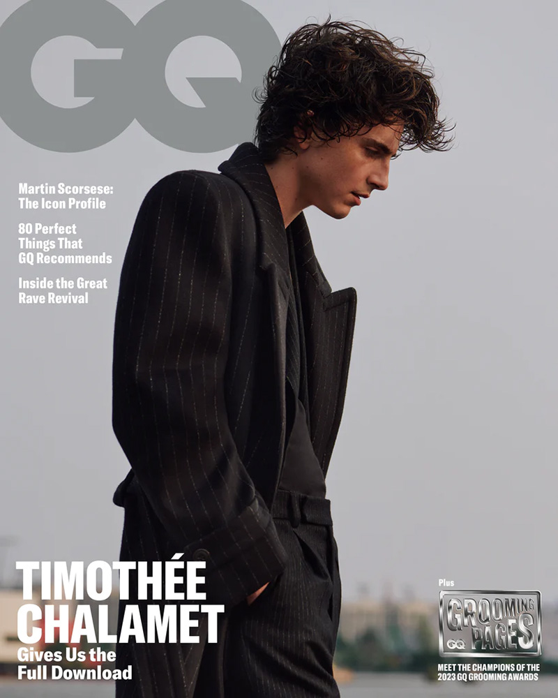 Capturing a pensive moment, Timothée Chalamet stands out in a textured pinstripe Saint Laurent suit, embodying a moody sophistication on the November 2023 GQ cover.
