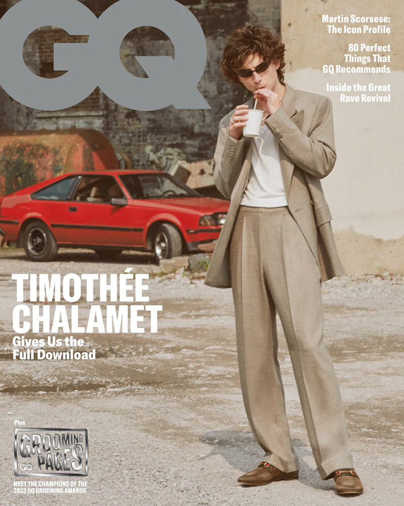 Timothée Chalamet channels urban cool with a casual sip of coffee, styled in a tailored beige Umit Benan B+ suit, on an edgy street corner for the GQ November 2023 cover.