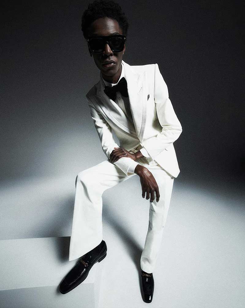 A crisp, white Tom Ford tuxedo paired with a black bow tie sets a tone of holiday elegance.