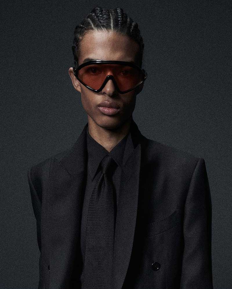Edgy meets executive as Isak Jawo showcases a modern take on the black suit accented with bold sunglasses.