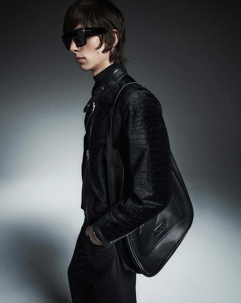Channeling a rockstar vibe, Julien Saunier poses in a textured leather jacket and oversized shades, complete with a sleek messenger bag.