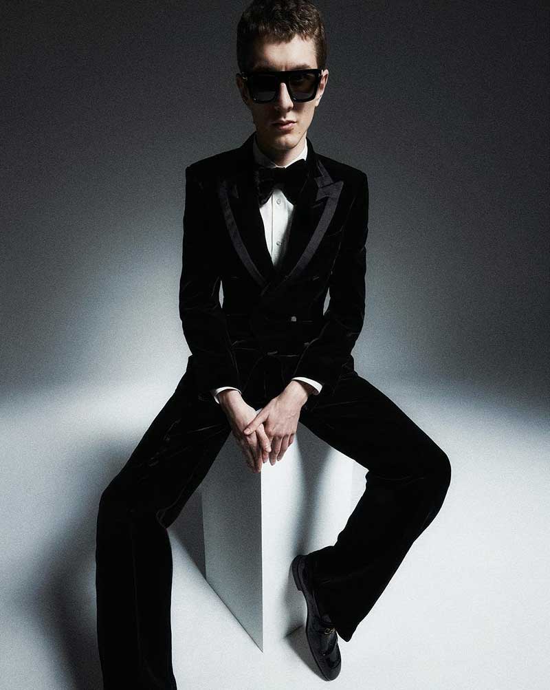 Henry Kitcher presents a timeless holiday style in a velvet Tom Ford tuxedo, adding a touch of festive sophistication.