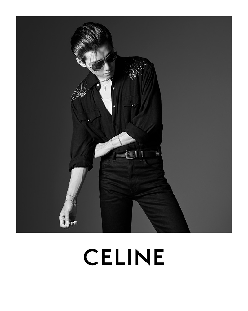 V strikes a dashing pose in studded black attire, accentuated by aviator sunglasses for Celine's edgy campaign.