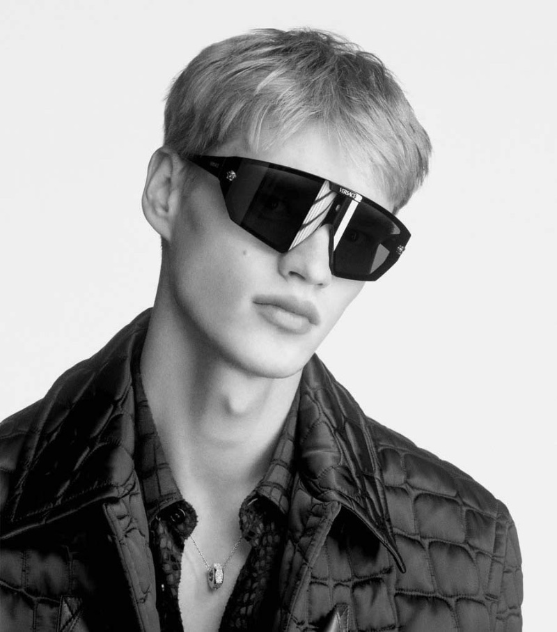 Model Filip Hrivnak wears Versace Maxi Medusa Horizon SGH Sunglasses for the brand's fall-winter 2023 campaign.