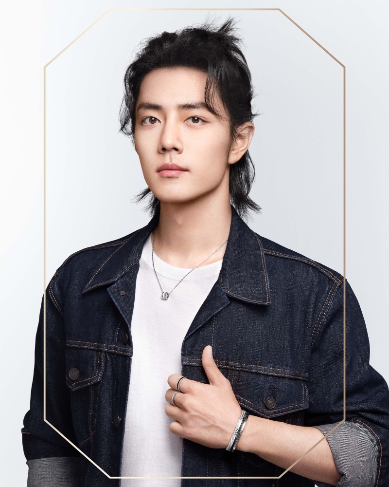 Actor Xiao Zhan goes casual in a denim jacket and Boucheron jewelry. 