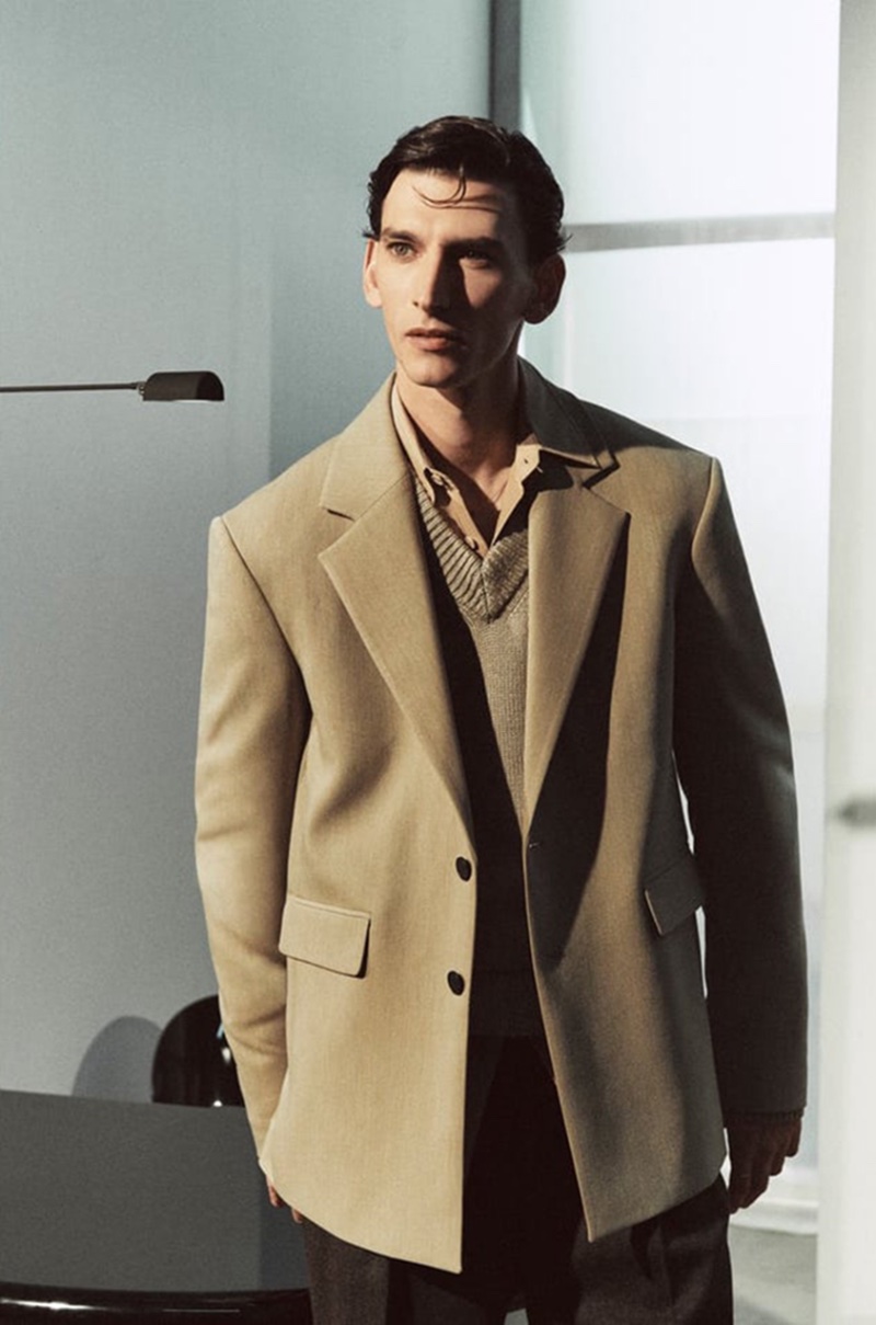 Thibaud Charon channels modern minimalism in a crisp, v-neck sweater and coat combination from Zara Edition.