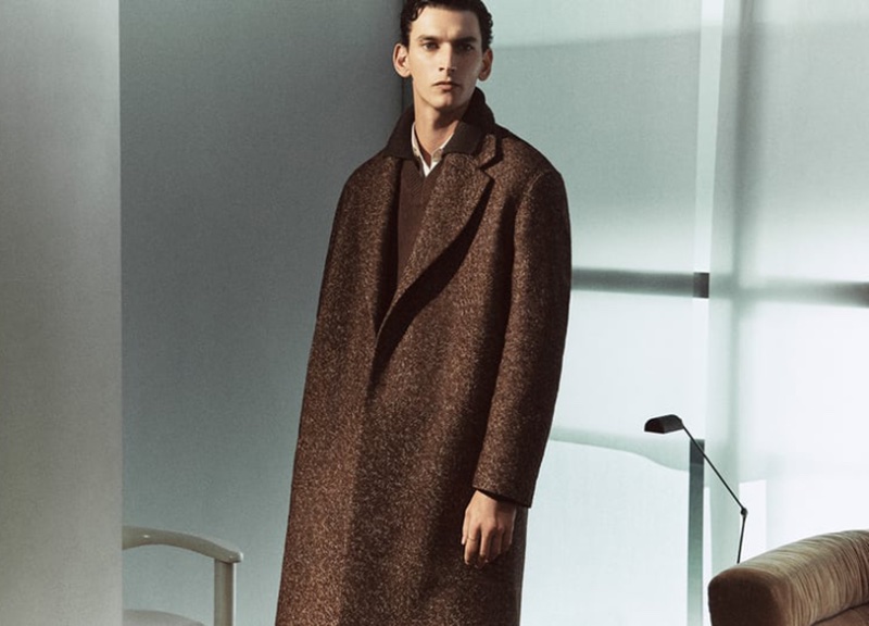 In a dramatic silhouette, Thibaud Charon wears a statement long coat from Zara Edition. 