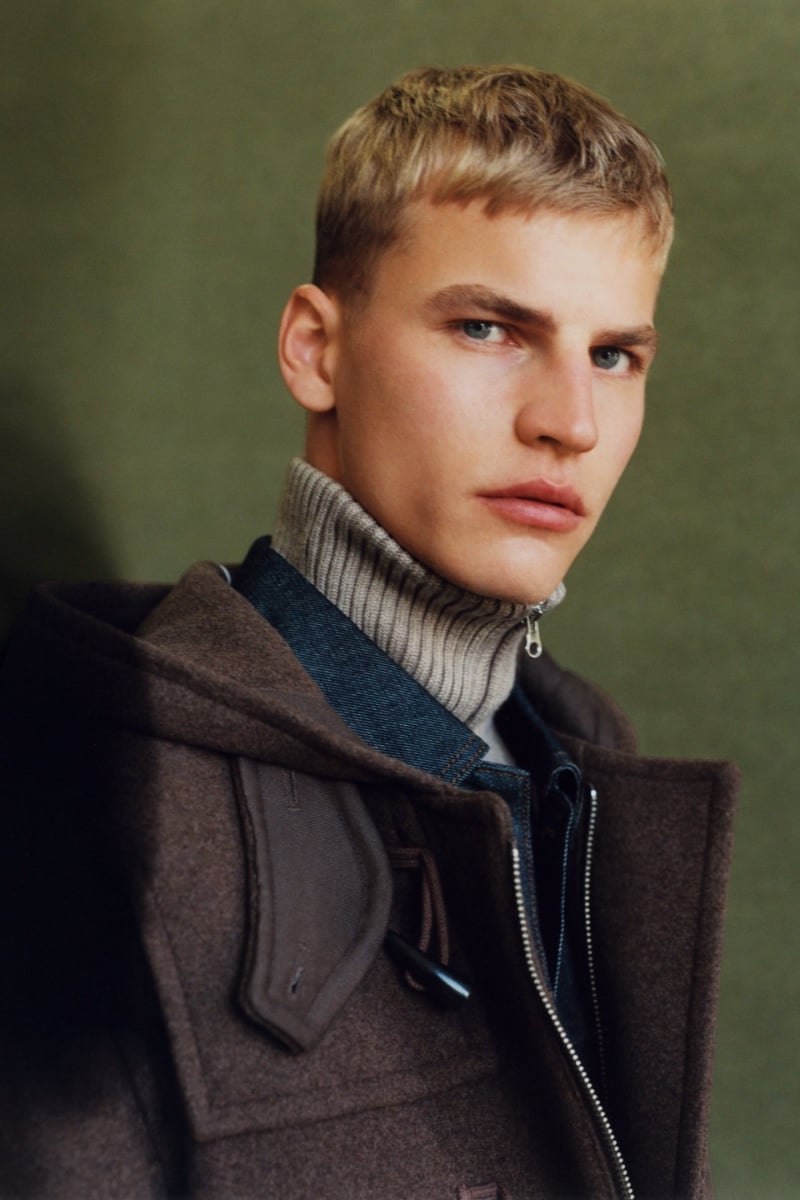Exuding winter elegance for Zara, Timo Pan wears a brown duffle coat with a turtleneck sweater. 