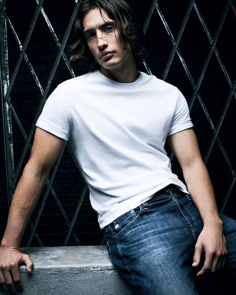 James Turlington models a classic white tee paired with AG Jeans' timeless denim.