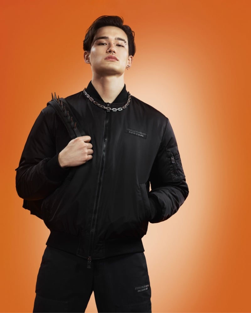 Wearing all black, Alex Schlab embodies urban cool in a bomber jacket and pants for Armani Exchange's fall-winter 2023 campaign.