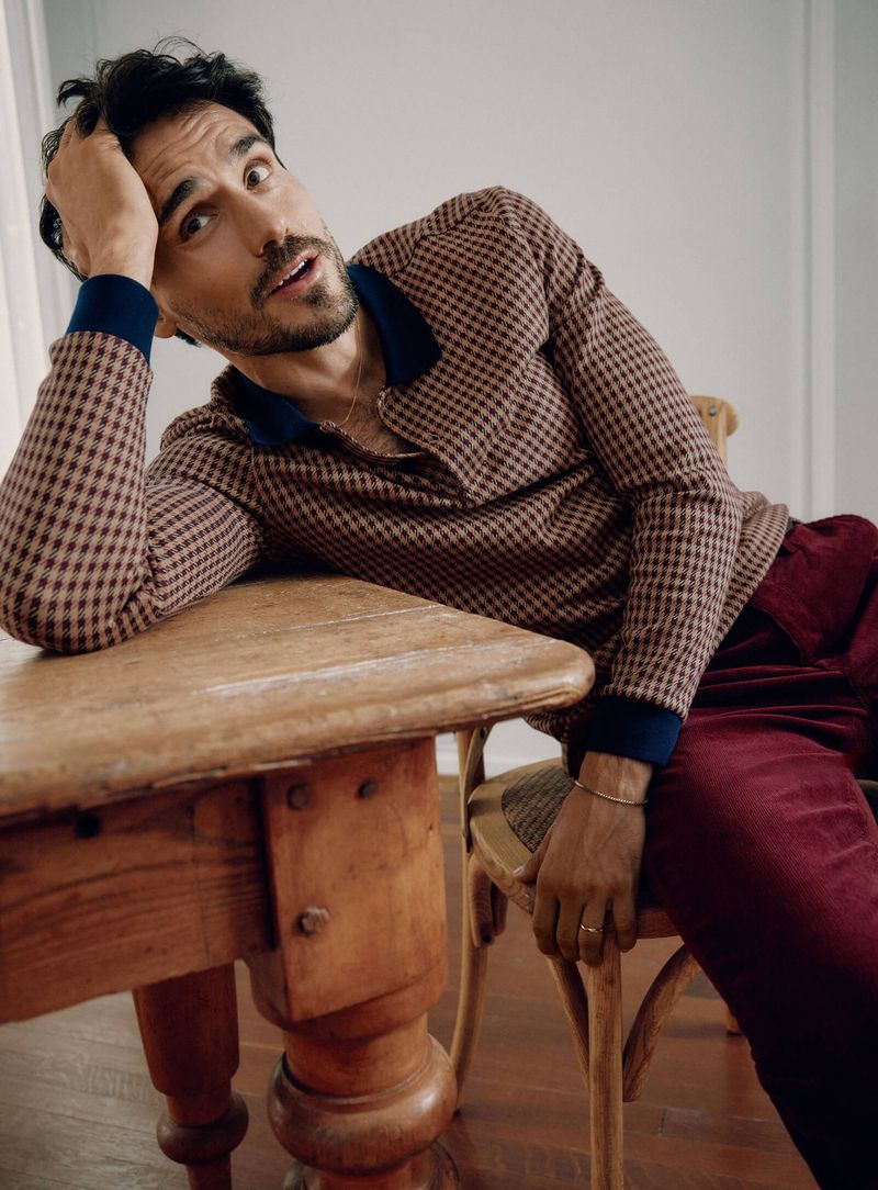 Stealing a quiet moment, Arthur Kulkov wears a long-sleeve houndstooth print polo with corduroy pants.