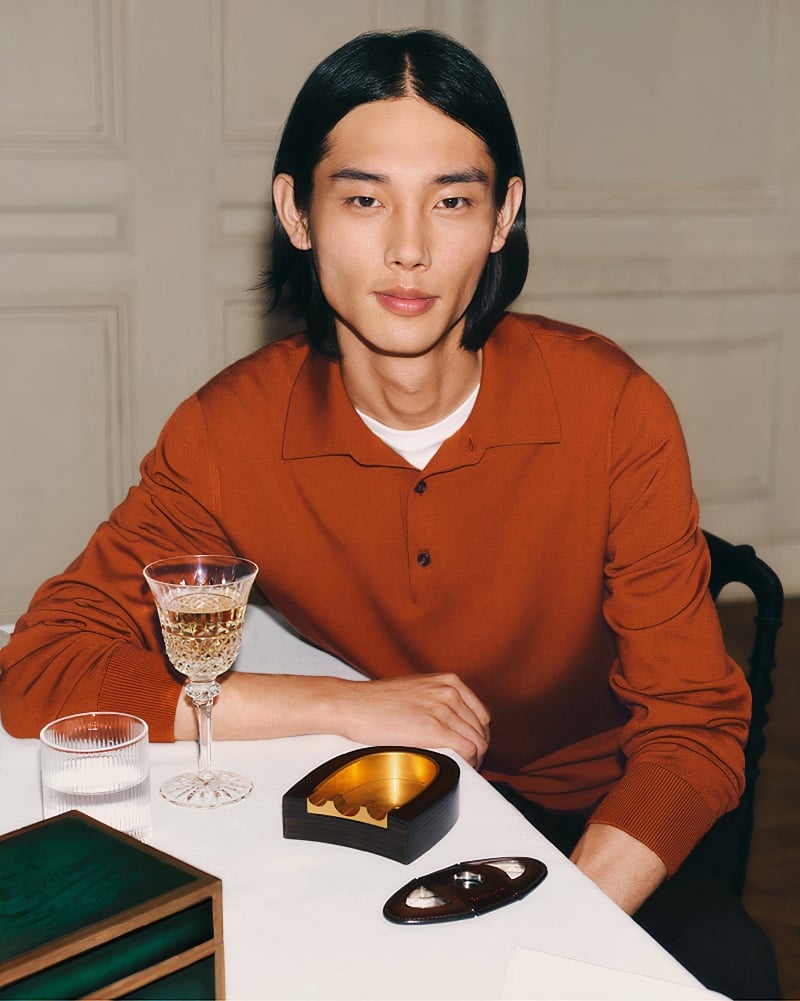 Taemin Park wears a terracotta polo for Berluti's holiday 2023 campaign.