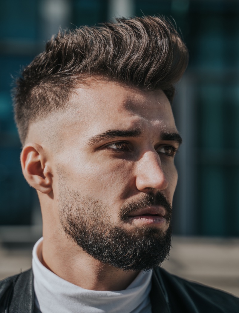 tousled black and red hair with cut Mohawk style