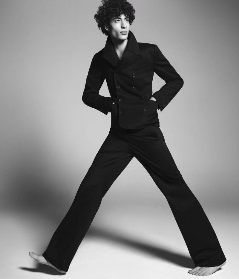 Yoesry Detre strikes a dynamic pose in a tailored peacoat outfit from Dolce & Gabbana's Marina collection. 