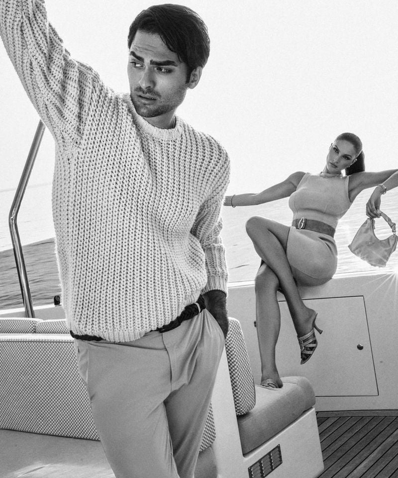 Matteo Bocelli and Oriola Marashi strike a casual yet elegant pose on a luxurious yacht for the GUESS holiday 2023 campaign.
