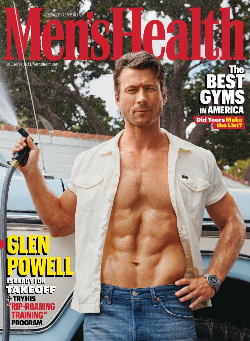 Glen Powell covers Men's Health in an unbuttoned Lee shirt, Levi's jeans, and an OMEGA watch. 