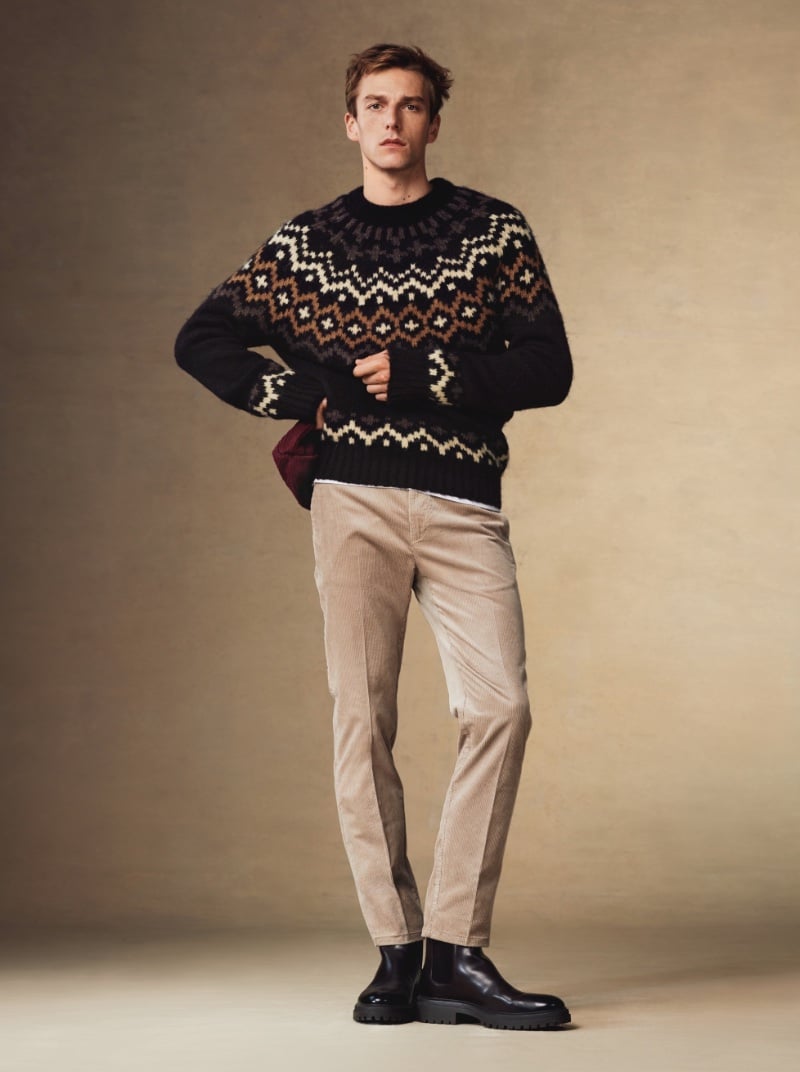 Quentin Demeester channels classic winter style in a traditional patterned knit sweater paired with pleated corduroy pants and polished black boots.