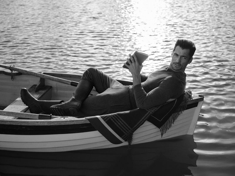 David Gandy lounges in a rowboat for the Hackett x David Gandy Wellwear campaign. 