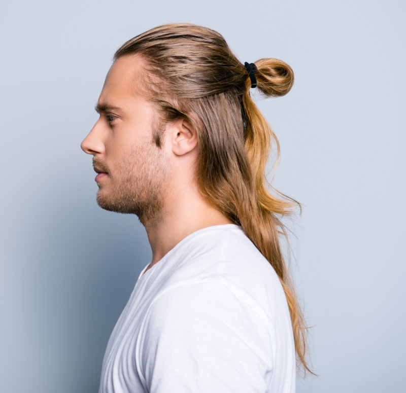 A man with a hairstyle Top Knot or A Man's Bun on a blue background, men's  hairstyles, hair care 18903177 Stock Photo at Vecteezy