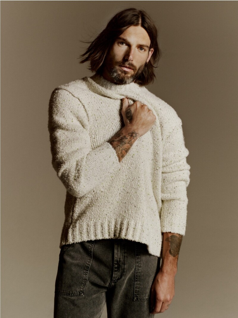 Charlie Wilson sports a 
Samsøe Samsøe wool-blend sweater with loose-fit jeans. 