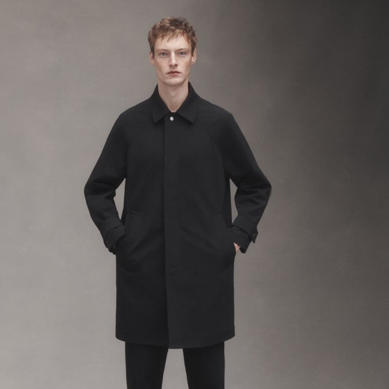 Roberto Sipos is a sharp figure in a sleek, black coat from JACQUES. 