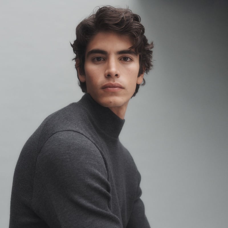 Sergio Perdomo models a charcoal turtleneck by JACQUES.