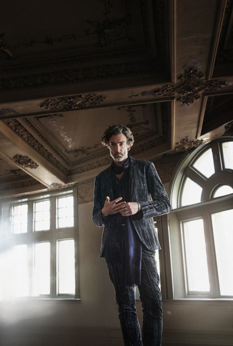 Model Richard Biedul stands with an air of commanding elegance in a John Varvatos jacquard suit.