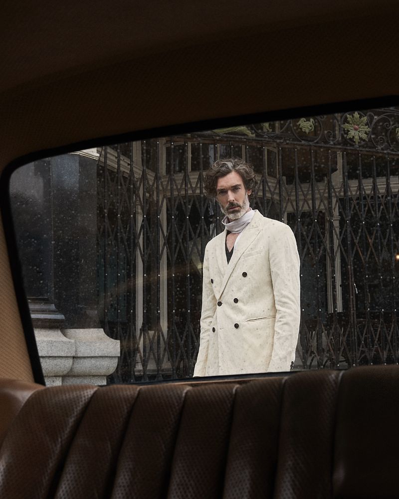 Donning a cream double-breasted jacket, Richard Biedul wears John Varvatos. 