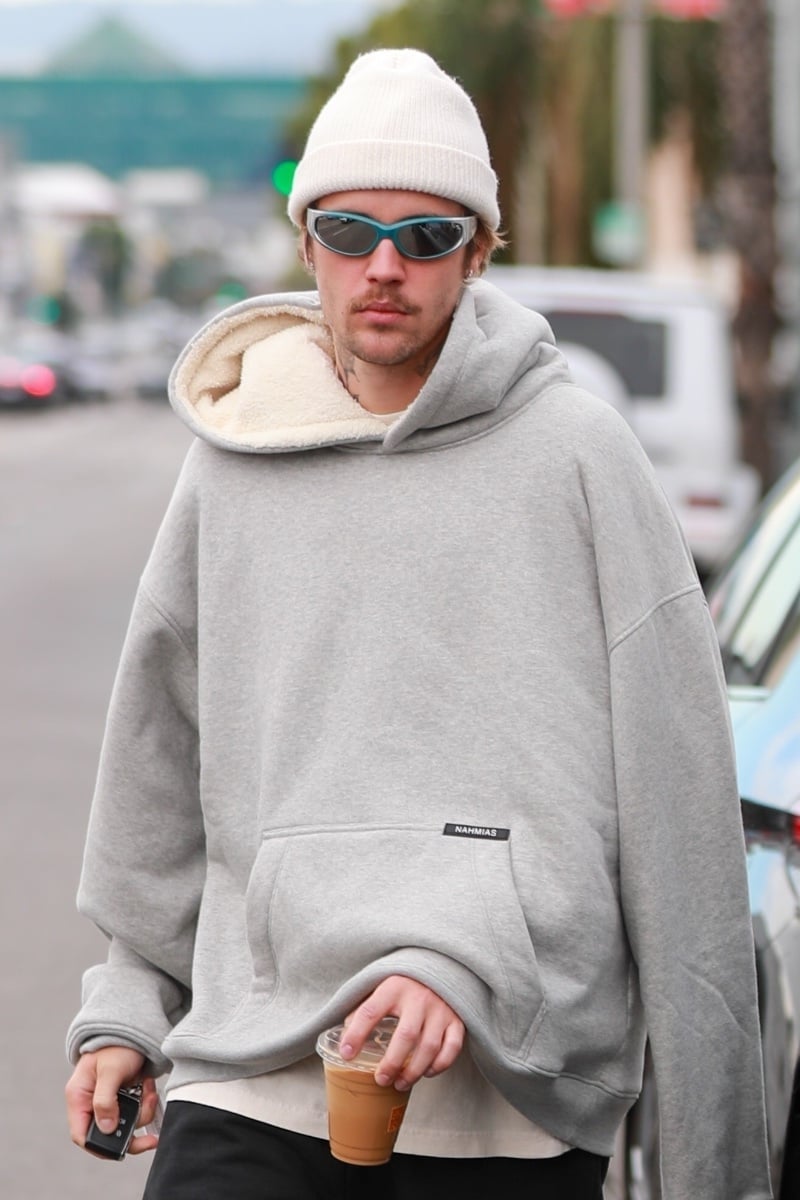 Justin Bieber steps out in Arnette's Catfish sunglasses and a Nahmias shearling hoodie.