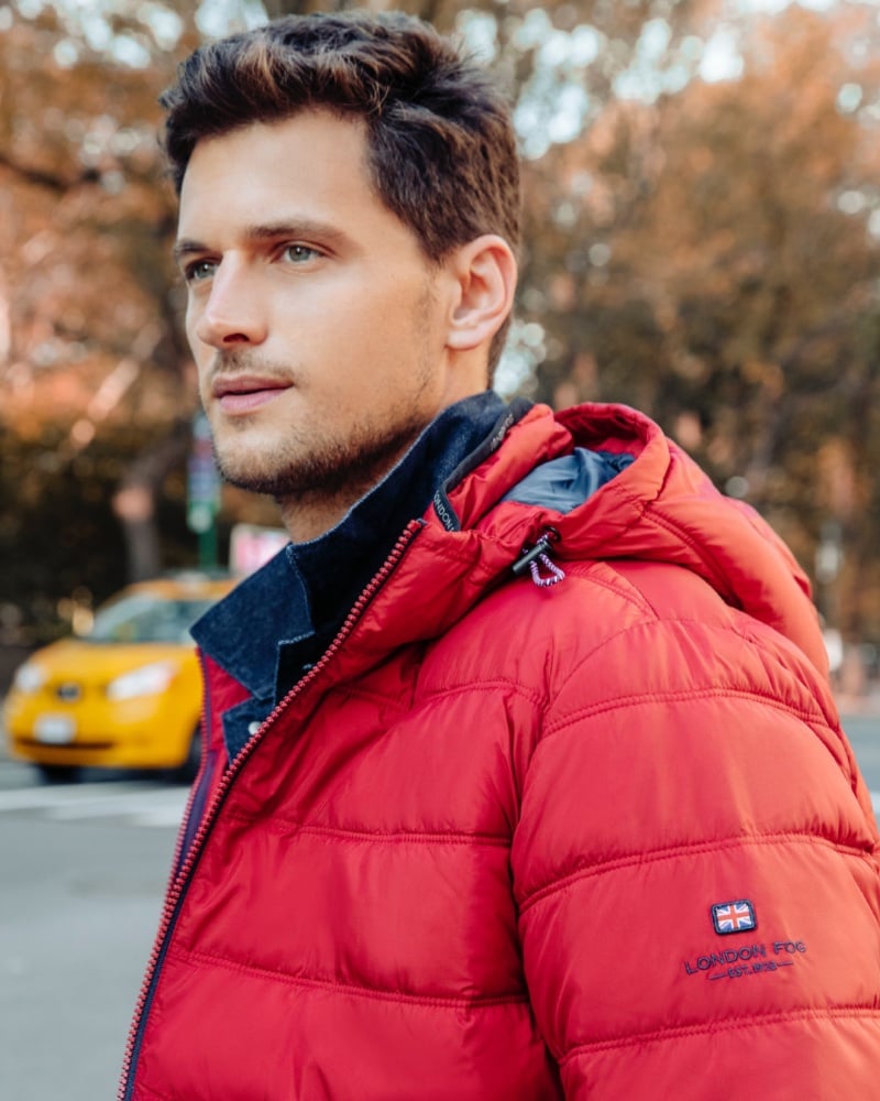 Garrett Neff is adorned in a vibrant red London Fog puffer jacket.