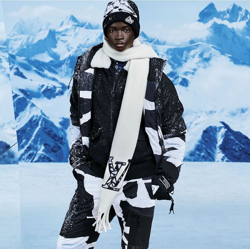 Amid a mountainous landscape, Ahmadou Gueye showcases a luxe winter look from Louis Vuitton.